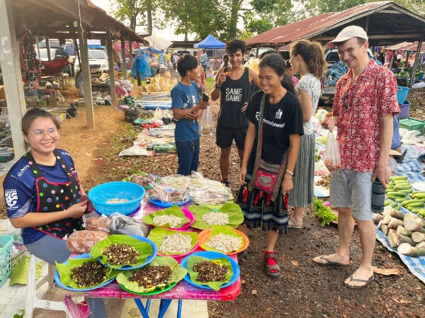 Tourists buying Insects at local market in Ubon Ratchathani