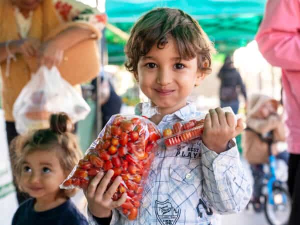 children enjoying thai organic tomatoes