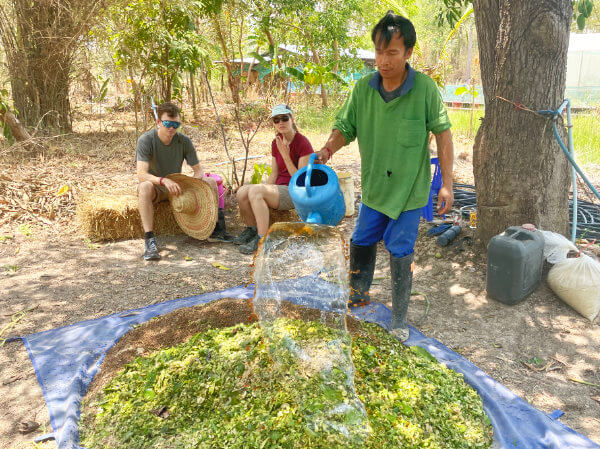 spraying microorganisms over compost materials in Ubon homestay